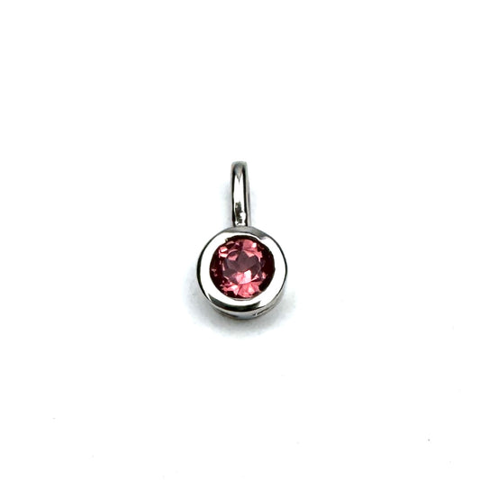 round pink gemstone pendant set in a silver bezel