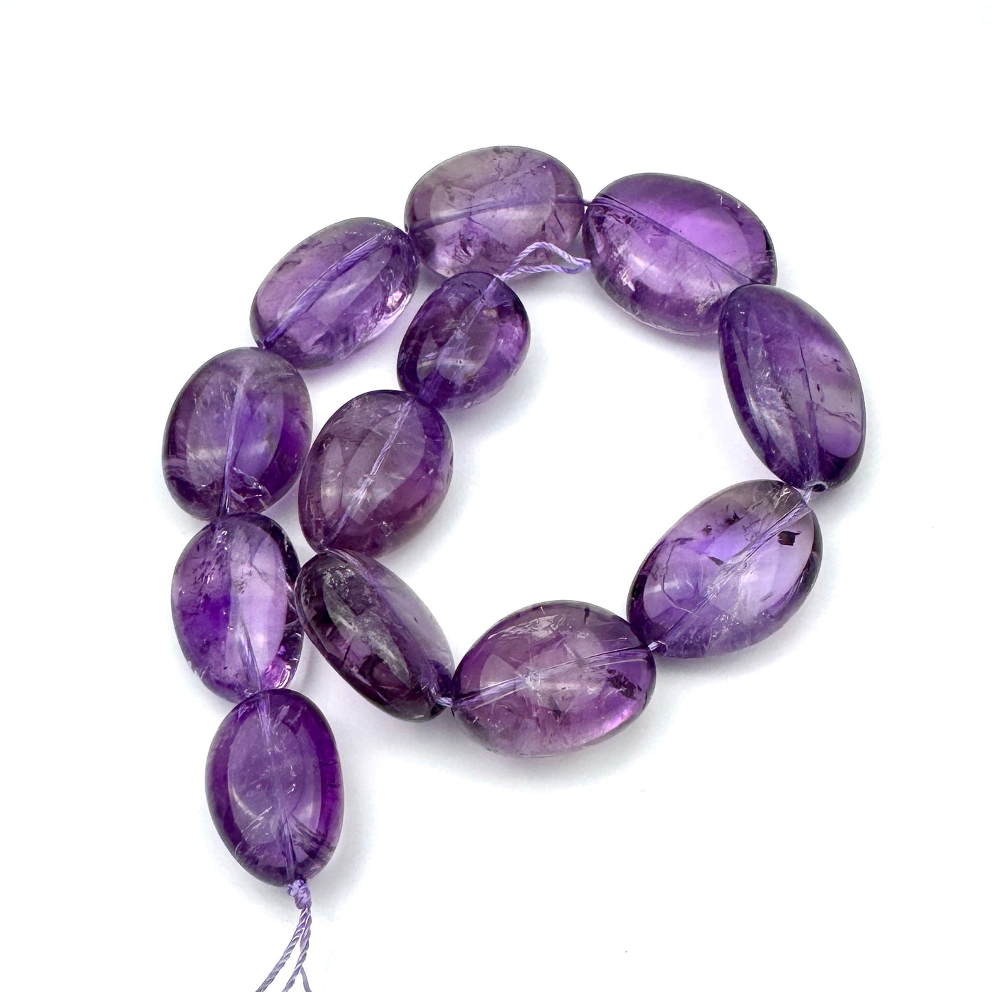 strand of amethyst beads with oval-shaped gemstones