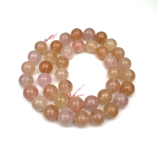 pink rose quartz gemstone beads arranged in a loop