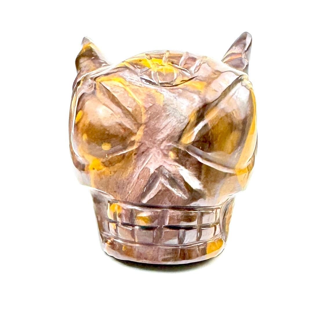 carved stone skull with yellow and brown hues