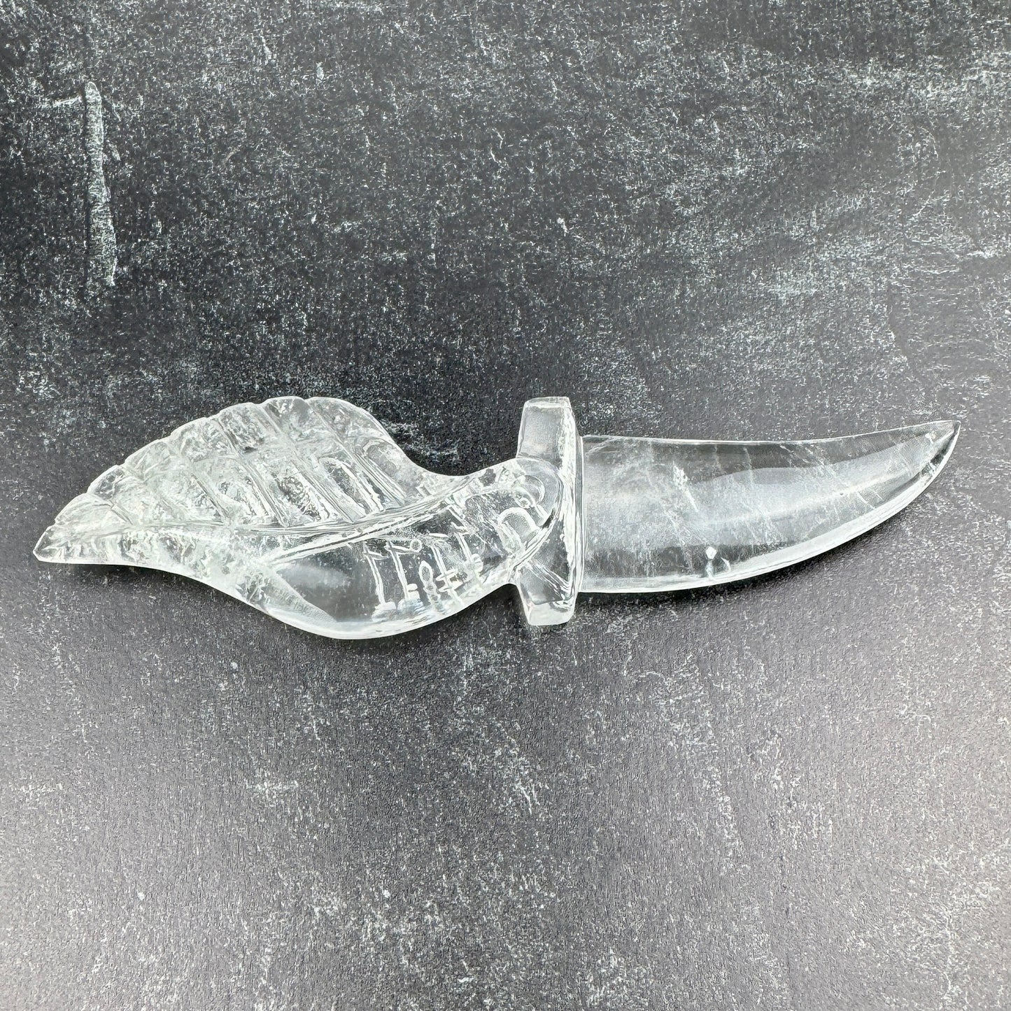 clear crystal knife with a leaf-shaped handle
