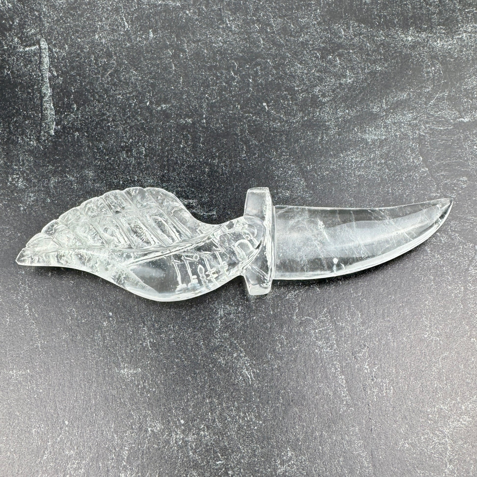 clear crystal knife with a leaf-shaped handle